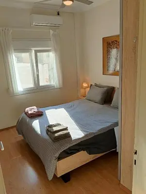 a bedroom with a bed with two towels on it at Athens Apartment in Athens
