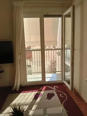 a room with a balcony with sliding glass doors at Athens Apartment in Athens