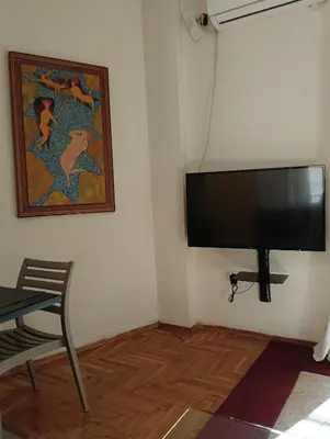 a flat screen tv hanging on a wall at Athens Apartment in Athens