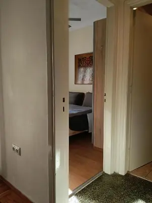 a hallway with a room with a bed in it at Athens Apartment in Athens