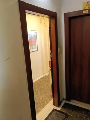 a hallway with a door open to a room at Athens Apartment in Athens