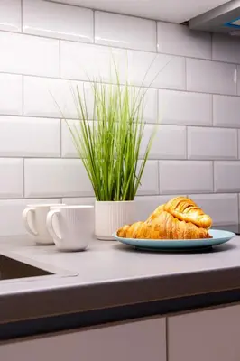 a plate of croissants on a counter in a kitchen at Lighthouse Kipseli in Athens