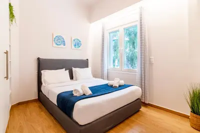 a bedroom with a bed with towels on it at Lighthouse Kipseli in Athens