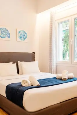 a bedroom with a large bed with towels on it at Lighthouse Kipseli in Athens