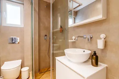 a bathroom with a shower and a sink and a toilet at Lighthouse Kipseli in Athens