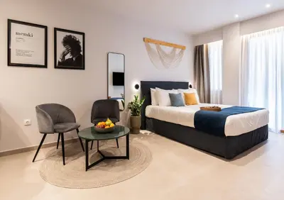 a bedroom with a bed and a table and chairs at PAME Apartments Athens in Athens