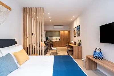 a bedroom with a bed and a living room at PAME Apartments Athens in Athens