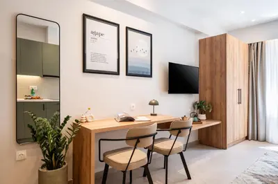 a home office with a desk and two chairs at PAME Apartments Athens in Athens