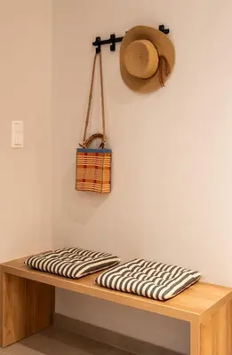 a hat sitting on top of a wooden shelf at PAME Apartments Athens in Athens