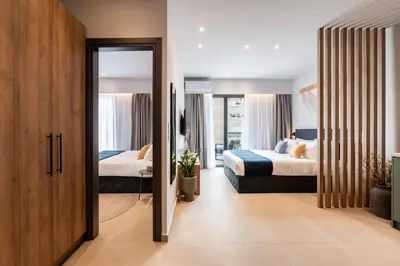 a hotel room with two beds and a mirror at PAME Apartments Athens in Athens