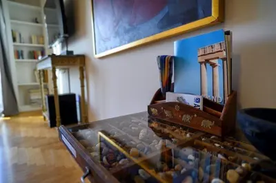 a glass table with rocks in a room at Athenian Artistic Apt Lycabettus View in Athens