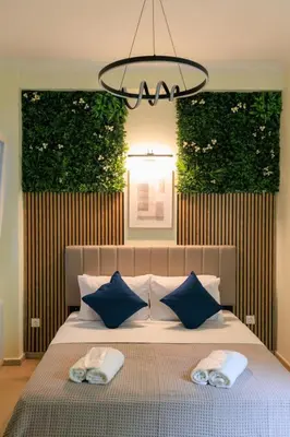 a bedroom with a bed with two towels on it at AIOLOS elegant escapes kolonaki in Athens