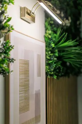 a light on a wall with plants on it at AIOLOS elegant escapes kolonaki in Athens