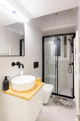 a bathroom with a sink and a toilet and a shower at AIOLOS elegant escapes kolonaki in Athens