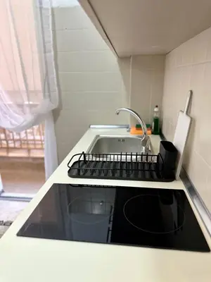 a kitchen counter with a sink and a keyboard at Arkadia`Kalithea in Athens