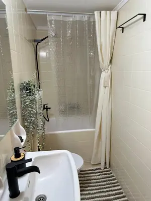 a white bathroom with a sink and a shower at Arkadia`Kalithea in Athens