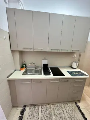 a kitchen with white cabinets and a sink at Arkadia`Kalithea in Athens