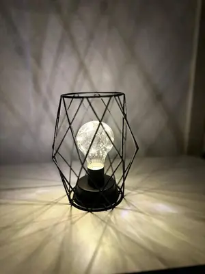 a black lamp with a light inside of it at Arkadia`Kalithea in Athens
