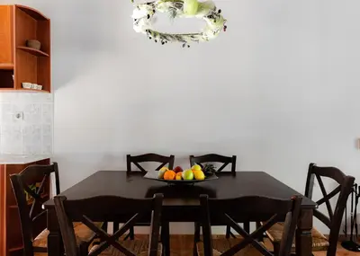 a dining room table with a bowl of fruit on it at Villieta Marina in Vaia