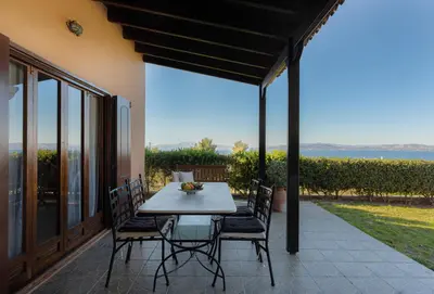 a table and chairs on a patio with a view at Villieta Marina in Vaia