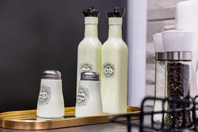 three bottles of milk on a wooden tray with a coffee at Miromar in Athens