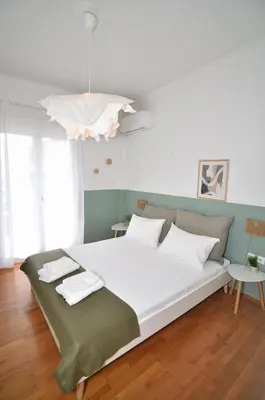 a bedroom with a large white bed with white pillows at Ifigenias Apartment-Near Acropolis-Koukaki in Athens