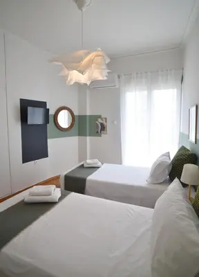 a hotel room with two beds and a mirror at Ifigenias Apartment-Near Acropolis-Koukaki in Athens