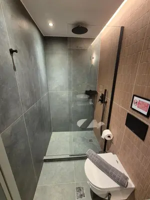a bathroom with a shower and a toilet at By The Stadium in Athens