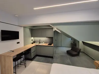 a room with a kitchen and a living room at By The Stadium in Athens
