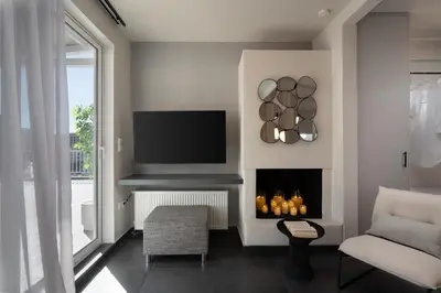 a living room with a fireplace and a tv at City View Penthouse with Large Terrace in Athens