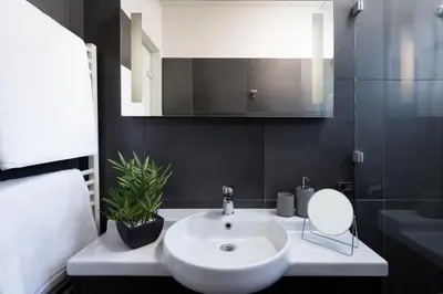 a bathroom with a white sink and a mirror at City View Penthouse with Large Terrace in Athens