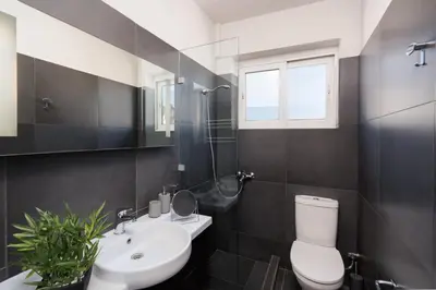 a bathroom with a white toilet and a sink at City View Penthouse with Large Terrace in Athens
