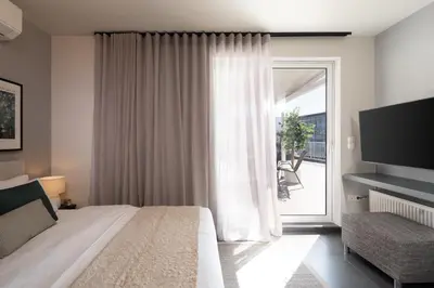 a bedroom with a bed and a sliding glass door at City View Penthouse with Large Terrace in Athens