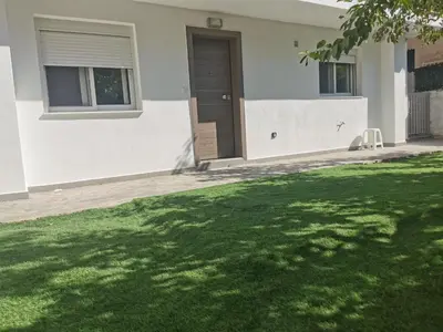 a house with a green lawn in front of it at GardenHouse in Athens