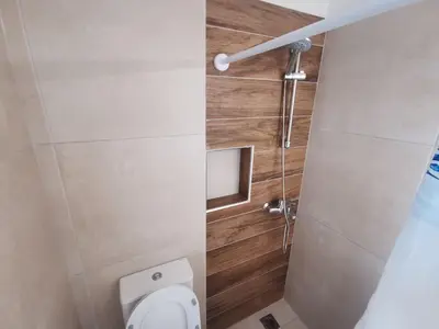 a small bathroom with a toilet and a shower at GardenHouse in Athens
