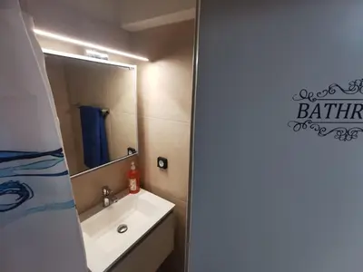 a bathroom with a sink and a mirror at GardenHouse in Athens