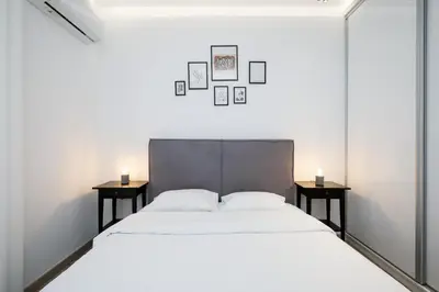 a bedroom with a large bed with two tables at Glyfada Golden Residence - 3 bedroom - Greecing in Athens