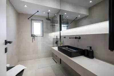 a bathroom with a black sink and a mirror at Glyfada Golden Residence - 3 bedroom - Greecing in Athens
