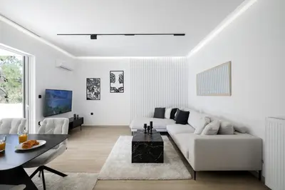 a white living room with a white couch and a table at Glyfada Golden Residence - 3 bedroom - Greecing in Athens
