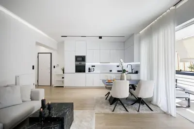 a living room with a couch and a table at Glyfada Golden Residence - 3 bedroom - Greecing in Athens