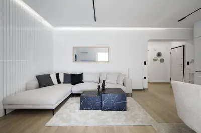 a white living room with a couch and a table at Glyfada Golden Residence - 3 bedroom - Greecing in Athens