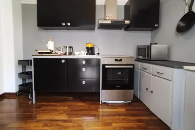 a kitchen with a stove and a microwave at Sunny Athens flat near the sea 2 in Athens