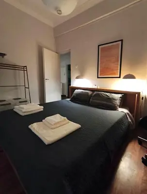 a bedroom with two towels sitting on a bed at Sunny Athens flat near the sea 2 in Athens