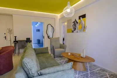 a living room with a couch and a table at Mesmerizing 2bedroom Luxury in Athens