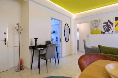 a dining room and living room with a table and chairs at Mesmerizing 2bedroom Luxury in Athens