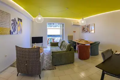 a living room with a couch and a table at Mesmerizing 2bedroom Luxury in Athens