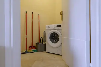 a washing machine in a room with baseball bats at Kastella's Amazing Islandic View in Piraeus