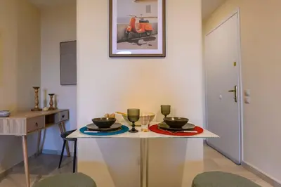 a small table with two bowls and glasses on it at Kastella's Amazing Islandic View in Piraeus