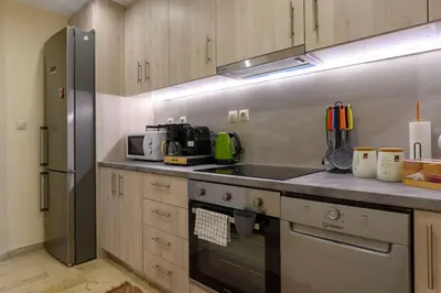 a kitchen with a stove and a refrigerator at Kastella's Amazing Islandic View in Piraeus