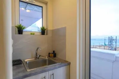 a kitchen with a sink and a window at Kastella's Amazing Islandic View in Piraeus